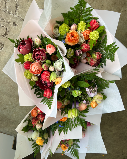Four colorful flower bouquets on a textured surface