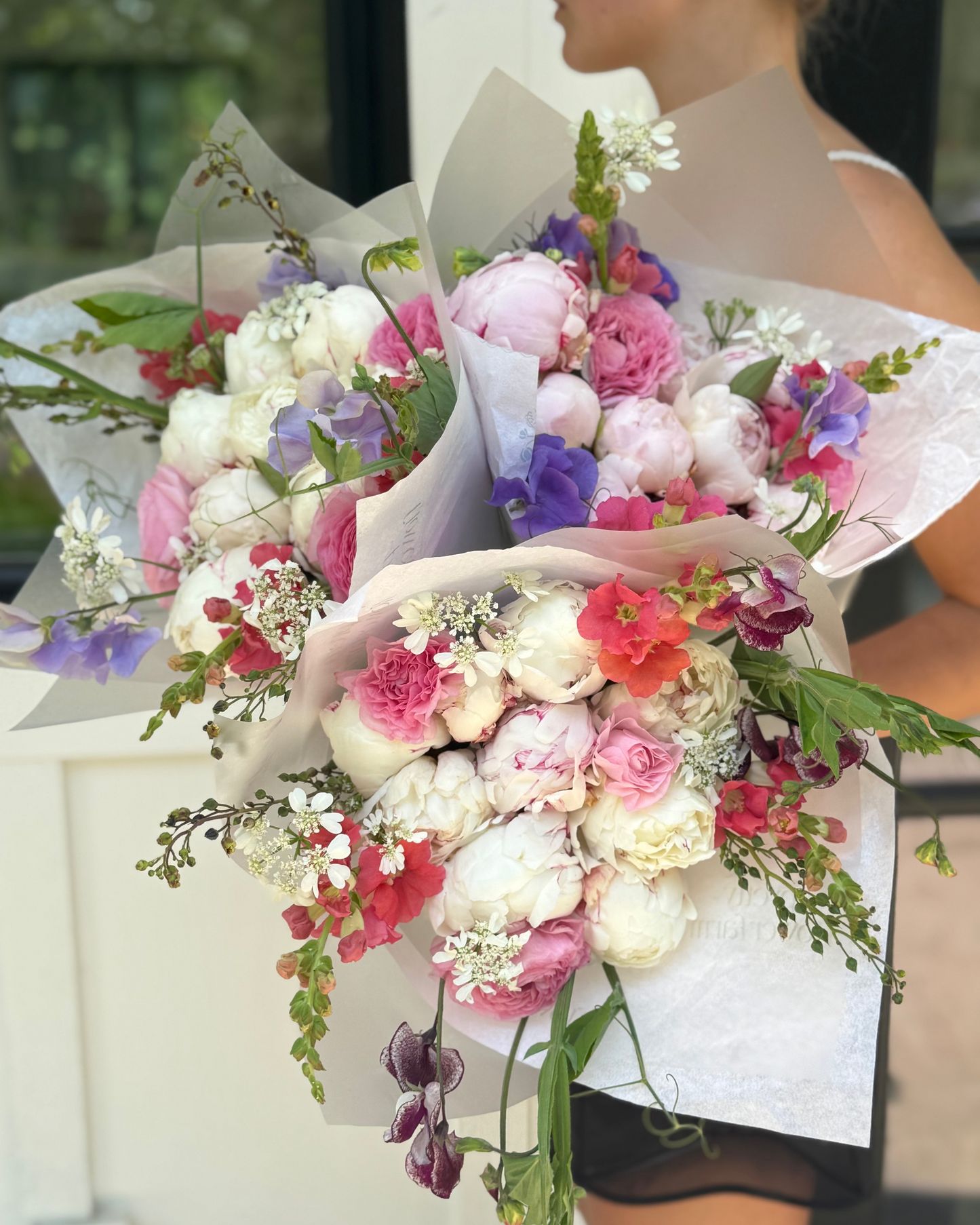 Bouquet of flowers held by a person with a blurred background