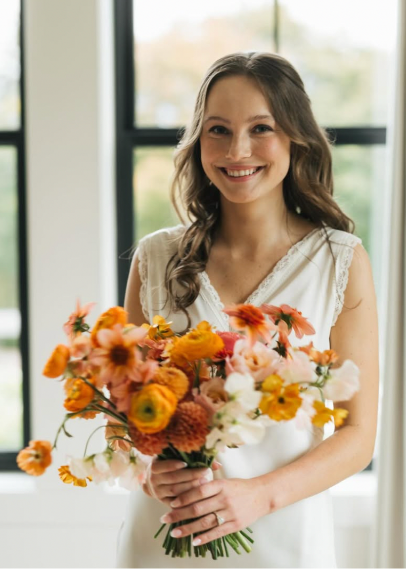 Woman holding a bouquet of flowers indoors